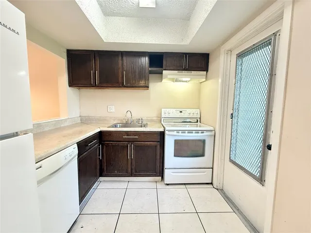 a kitchen with stainless steel appliances a stove a sink and a microwave