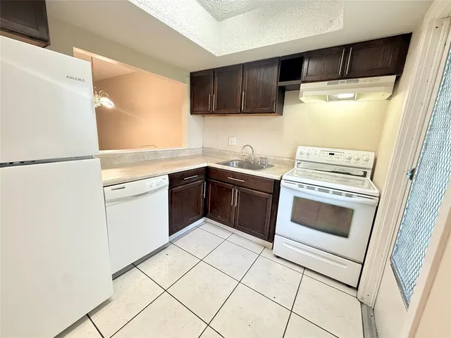 a kitchen with a stove sink and refrigerator