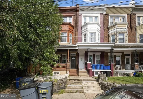 a view of a building with sitting area and furniture