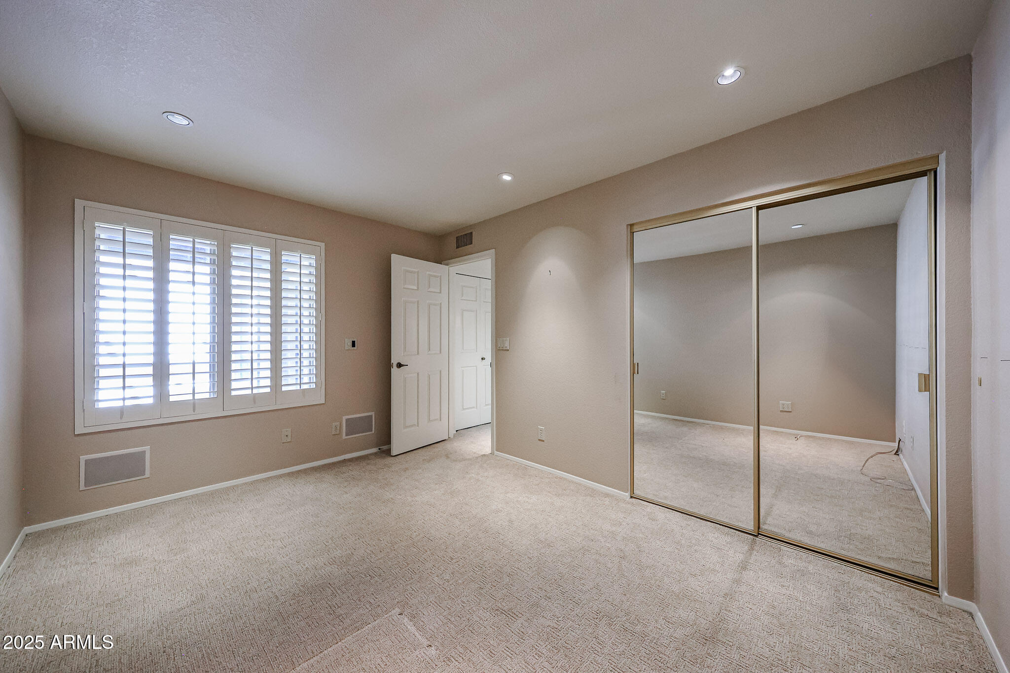 7834 East Ocotillo Road Scottsdale, AZ 85250 - Photo 12 of 47 a view of an empty room with a window