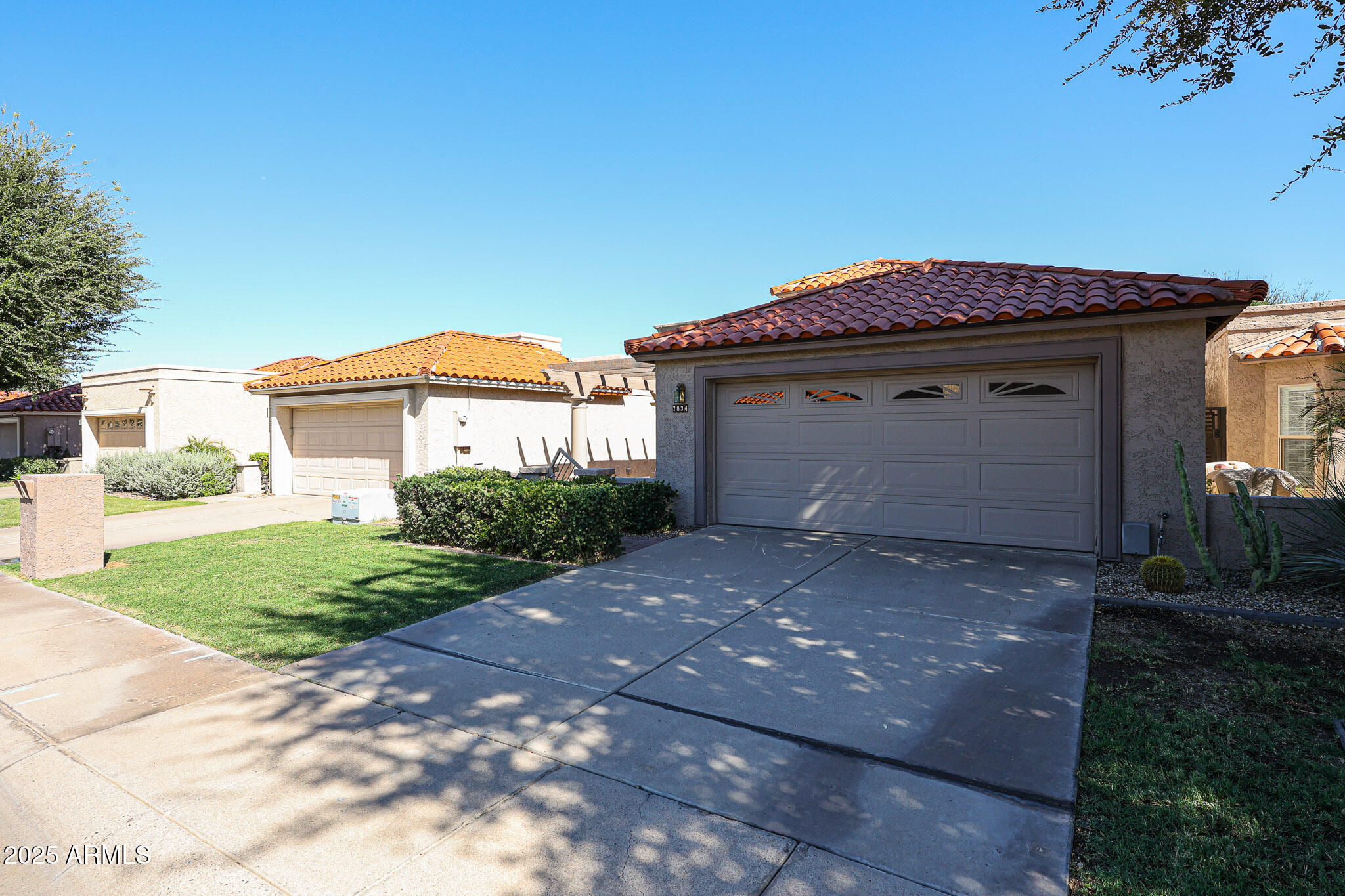 7834 East Ocotillo Road Scottsdale, AZ 85250 - Photo 2 of 47 a front view of a house with a yard and garage