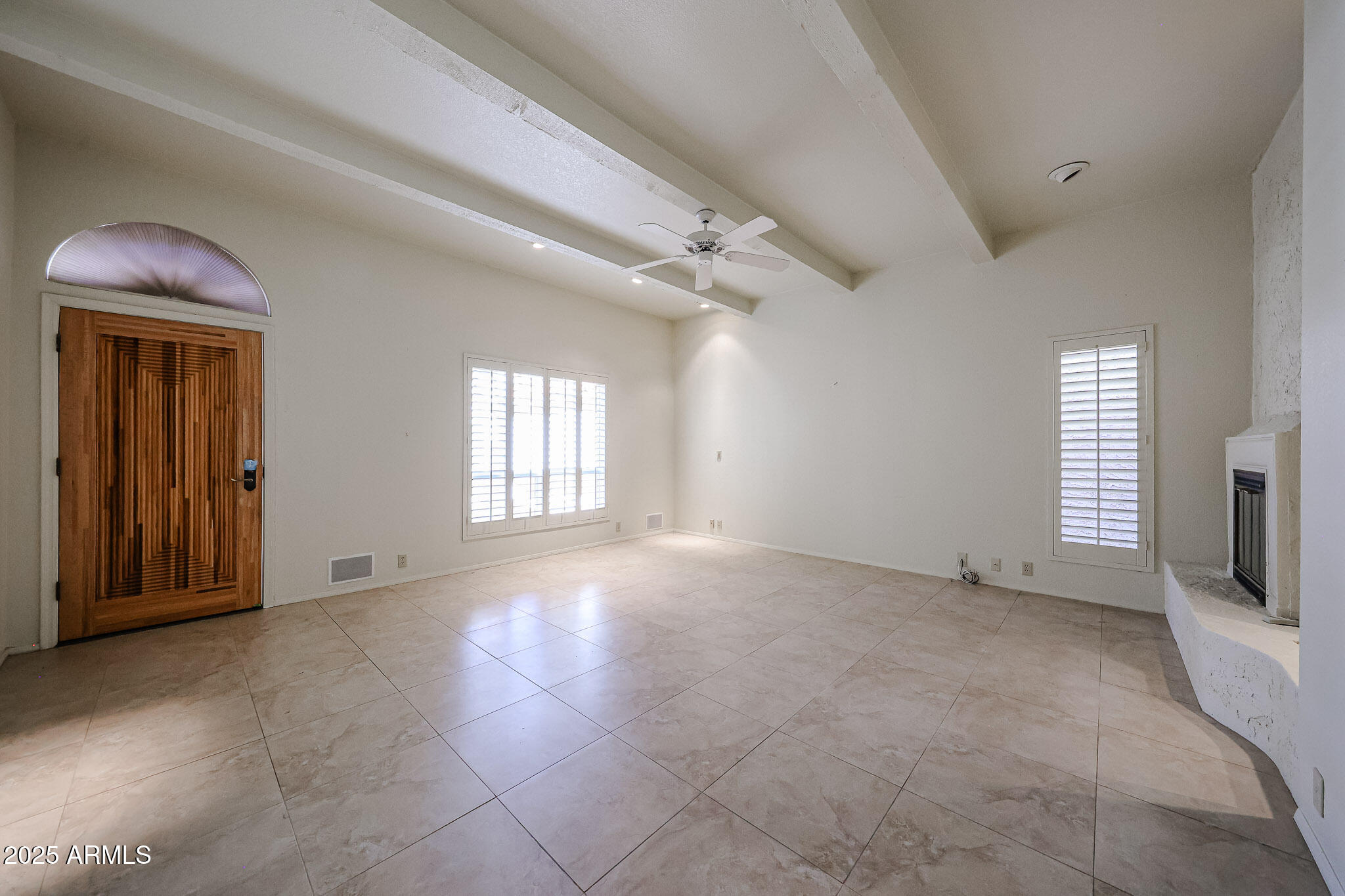 7834 East Ocotillo Road Scottsdale, AZ 85250 - Photo 28 of 47 a view of an empty room with a fireplace and a window