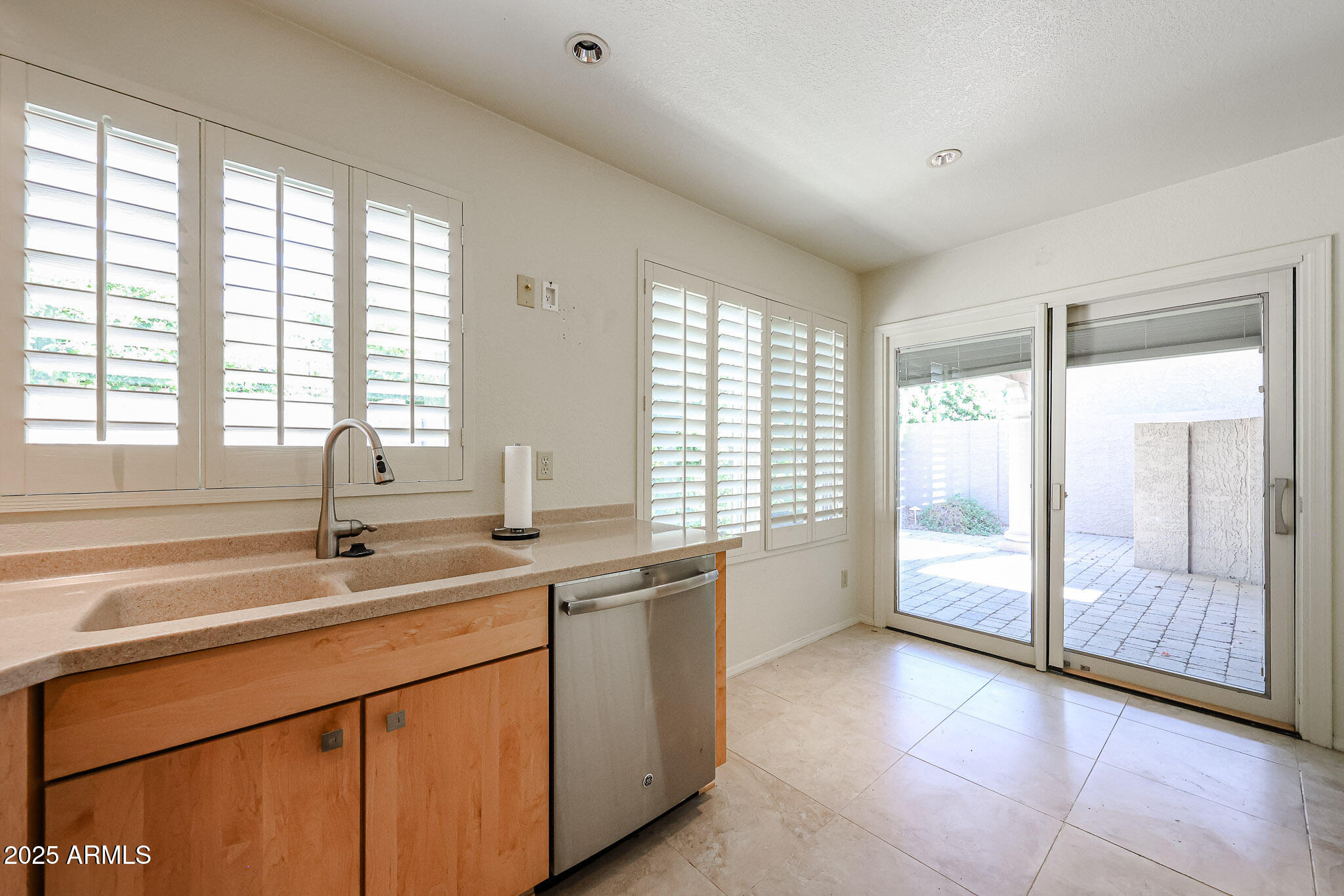 7834 East Ocotillo Road Scottsdale, AZ 85250 - Photo 7 of 47 a kitchen with stainless steel appliances granite countertop a sink and a large window