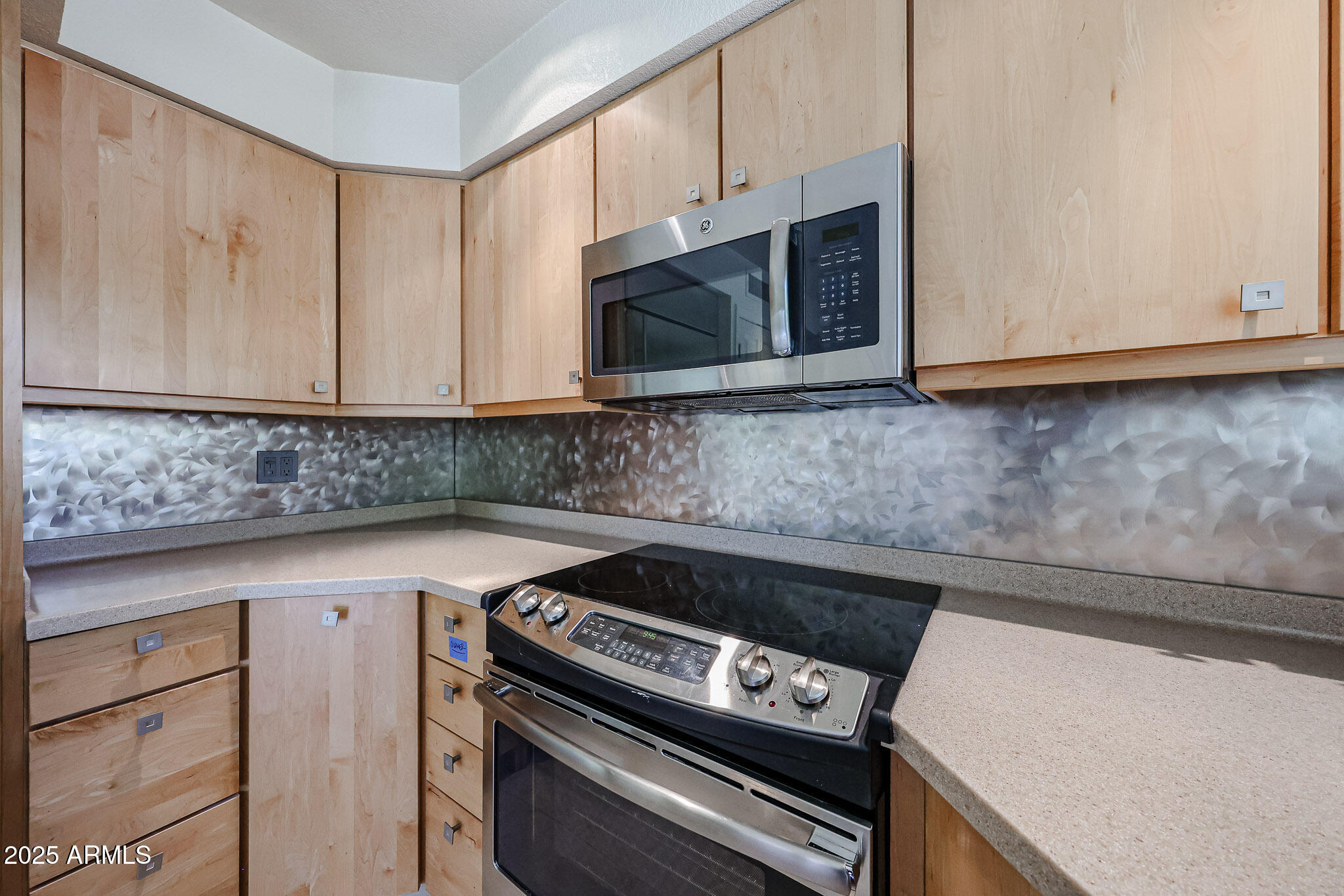 7834 East Ocotillo Road Scottsdale, AZ 85250 - Photo 9 of 47 a kitchen with granite countertop cabinets stove top oven and microwave