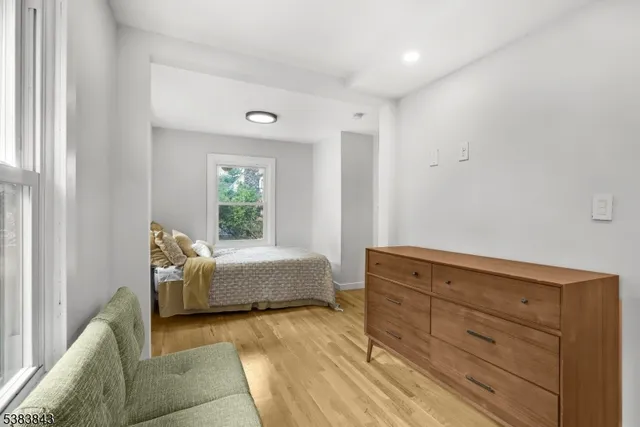 a spacious bedroom with a bed and a window