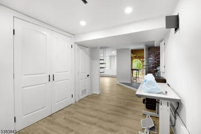 a hallway with furniture and wooden floor