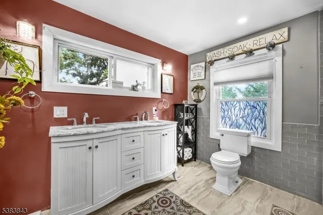 a spacious bathroom with a toilet sink and mirror