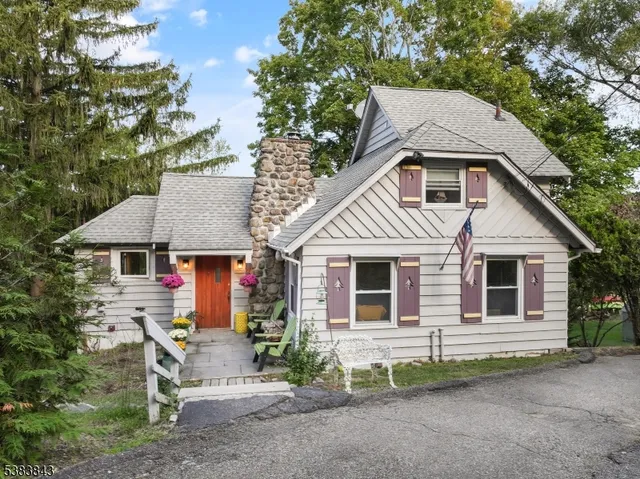 a front view of a house with a garden and yard