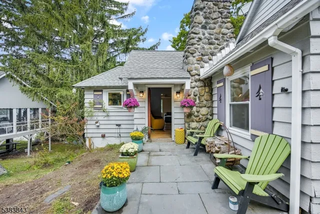 an aerial view of residential houses with outdoor space and trees