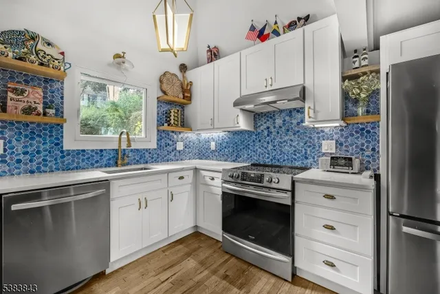 a kitchen with granite countertop cabinets stainless steel appliances and a window
