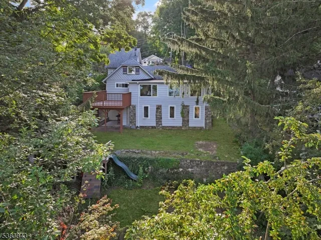 a view of a porch with a table and chairs and potted plants