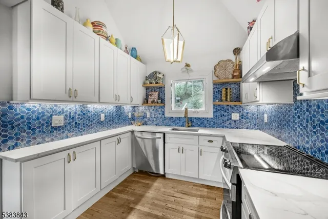 a kitchen with granite countertop white cabinets and white appliances