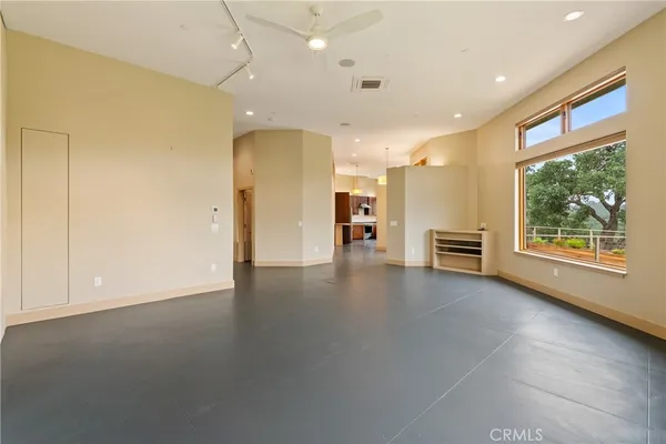 a living room with furniture flat screen tv and large window