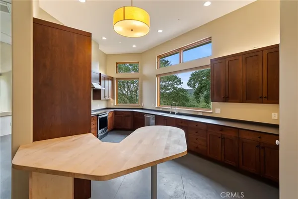 a kitchen with stainless steel appliances a sink a stove and a window