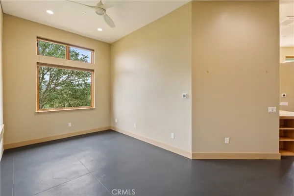 a view of a hallway with wooden floor and a cabinet