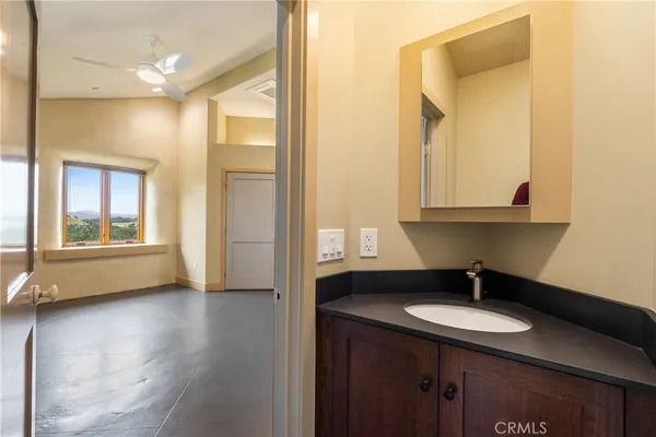 a bathroom with double vanity and a mirror