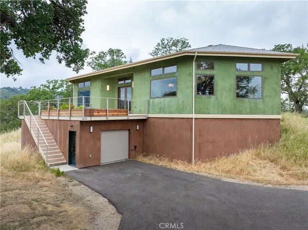a view of a patio with table and chairs with wooden floor and fence