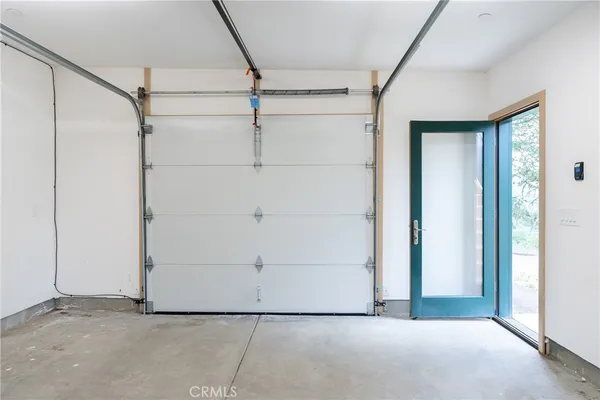 an outdoor space with seating area and trees around