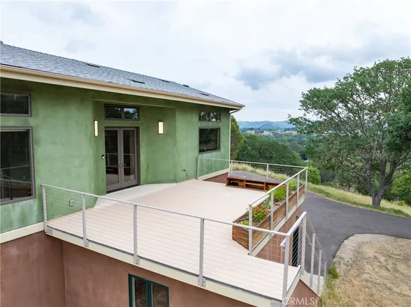 a view of a patio with table and chairs and potted plants
