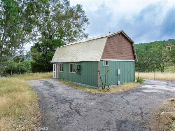 an empty room with a fireplace and windows