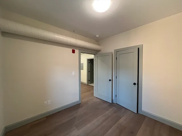 a view of hallway with wooden floor