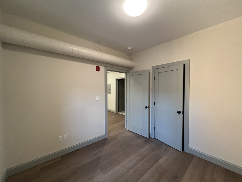 160 Seabury Street, Unit 13 Fall River, MA 02720 - Photo 7 of 8 a view of hallway with wooden floor