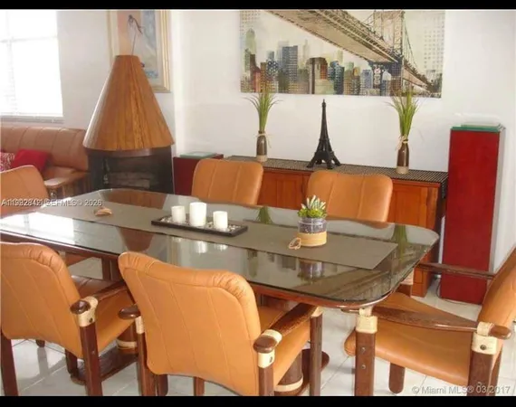 a living room with dining table and a couch