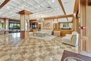 a living room with fireplace furniture and a large window