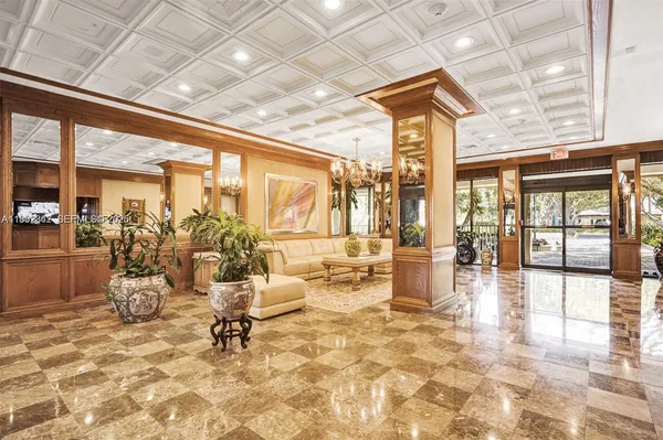 a lobby with furniture and floor to ceiling window
