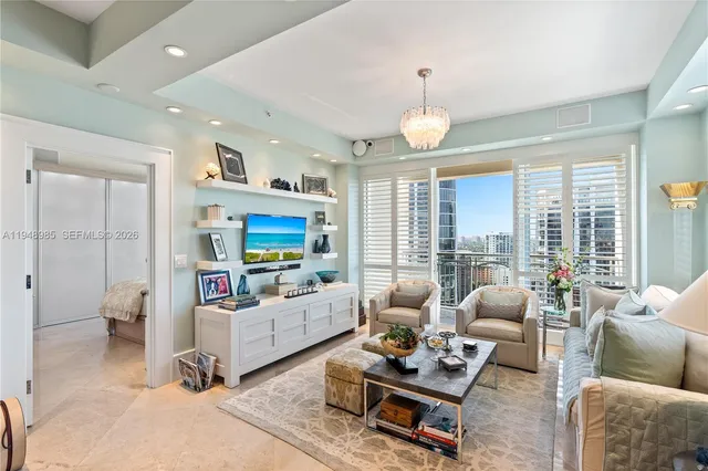 a dining room with furniture and a large window
