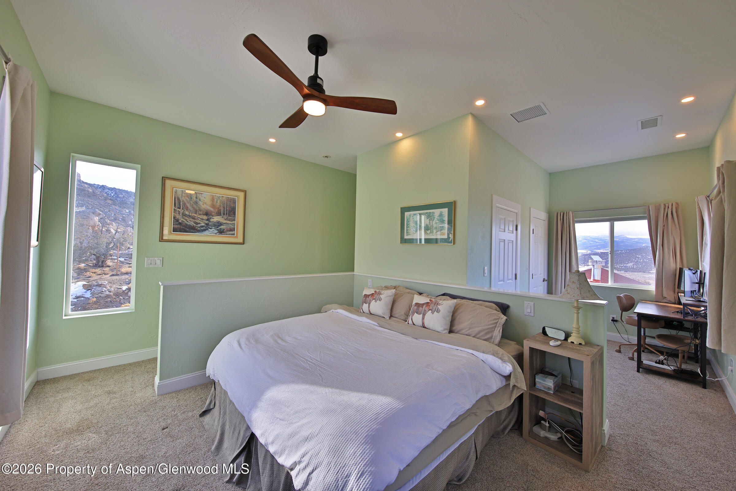 15086 45 45 1/2 Road De Beque, CO 81630 - Photo 15 of 40 a bedroom with a large bed and a chandelier