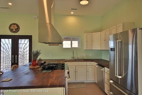 a kitchen with a sink cabinets and appliances