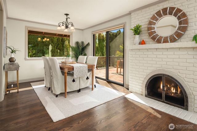 a living room with furniture a fireplace and a floor to ceiling window