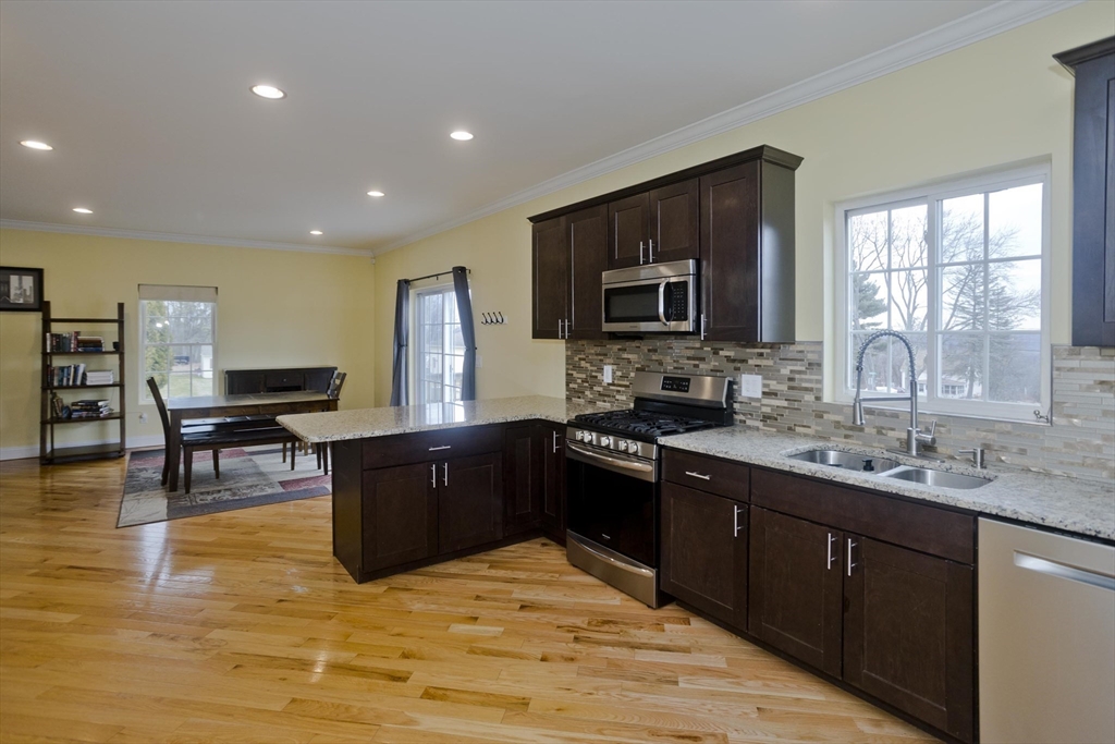 48 Mountain Avenue West Springfield, MA 01089 - Photo 16 of 39 a kitchen with stainless steel appliances granite countertop a stove sink microwave and cabinets