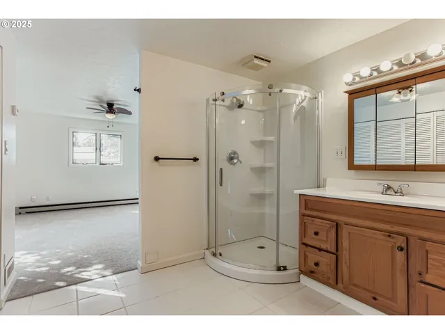 a bathroom with a granite countertop sink mirror and a toilet