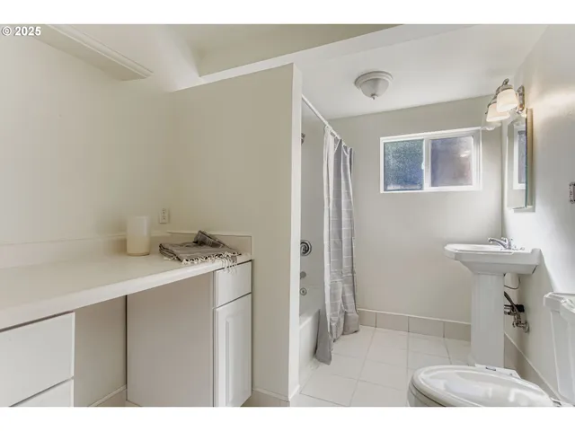 a bathroom with a sink a mirror and a window