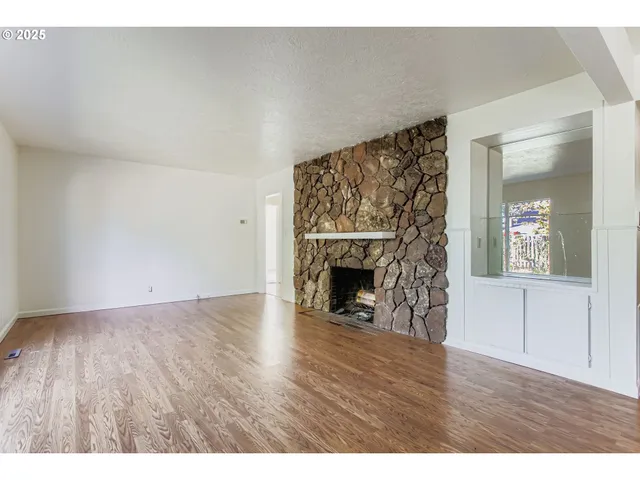 a view of an empty room and wooden floor