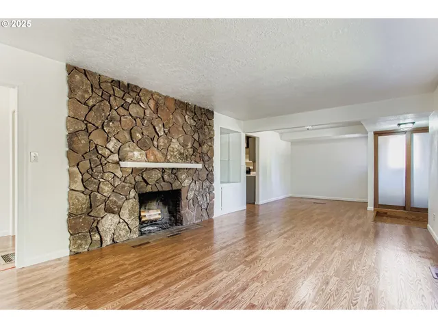 a view of an empty room and wooden floor