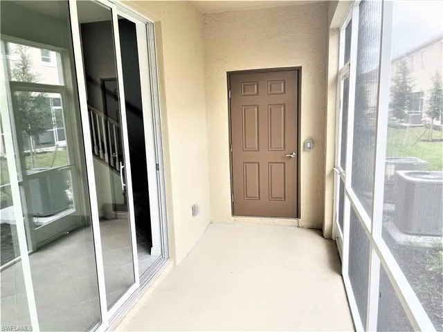 a view of a walk in closet with wooden floor and bedroom