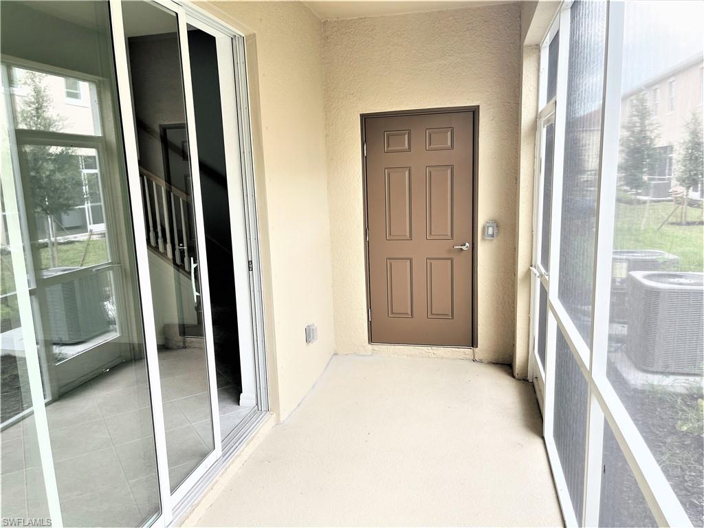 2775 Blossom Way Naples, FL 34120 - Photo 16 of 16 a view of a walk in closet with wooden floor and bedroom