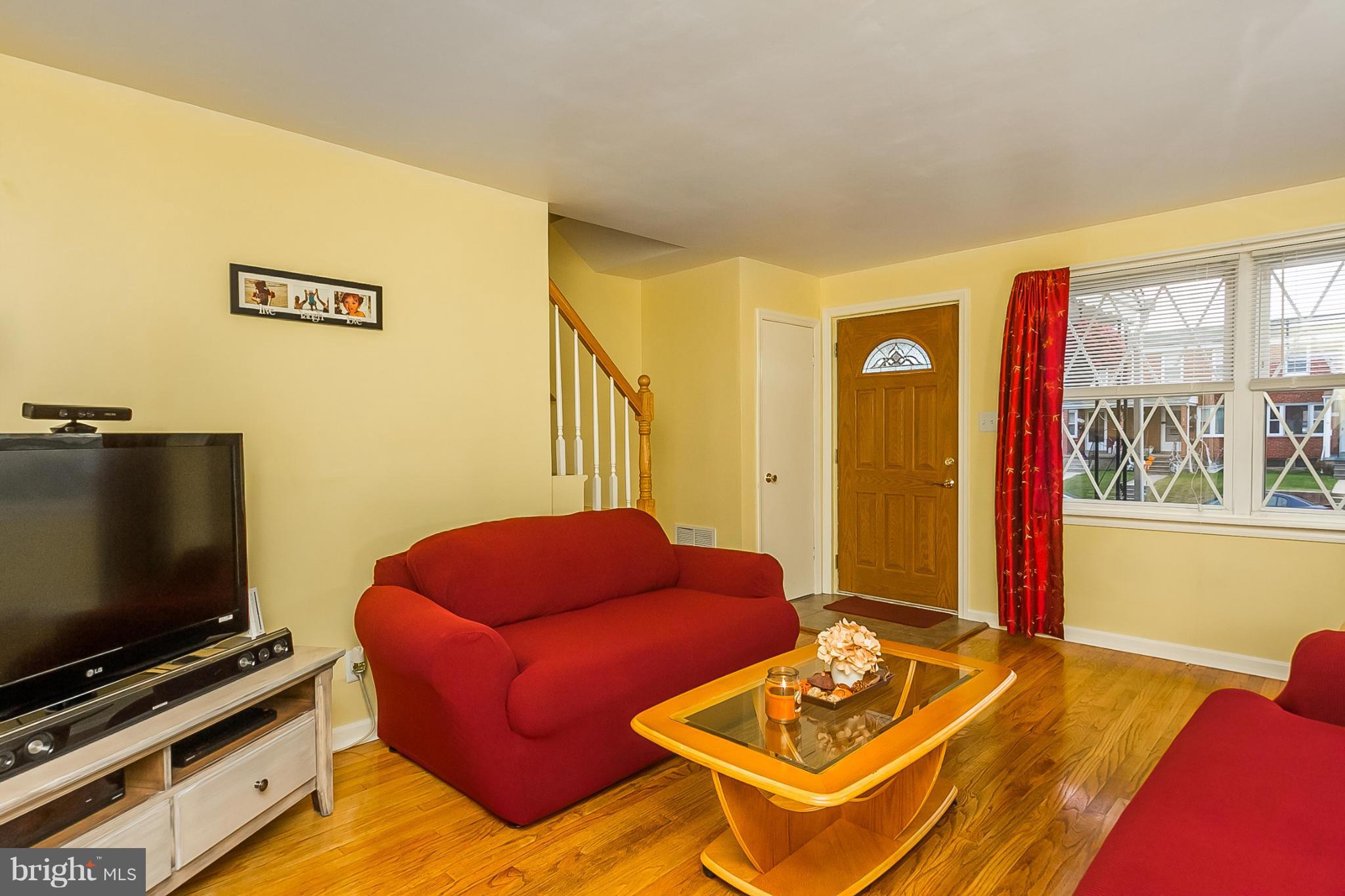 716 Aldworth Road Baltimore, MD 21222 - Photo 2 of 29 a living room with furniture and a flat screen tv