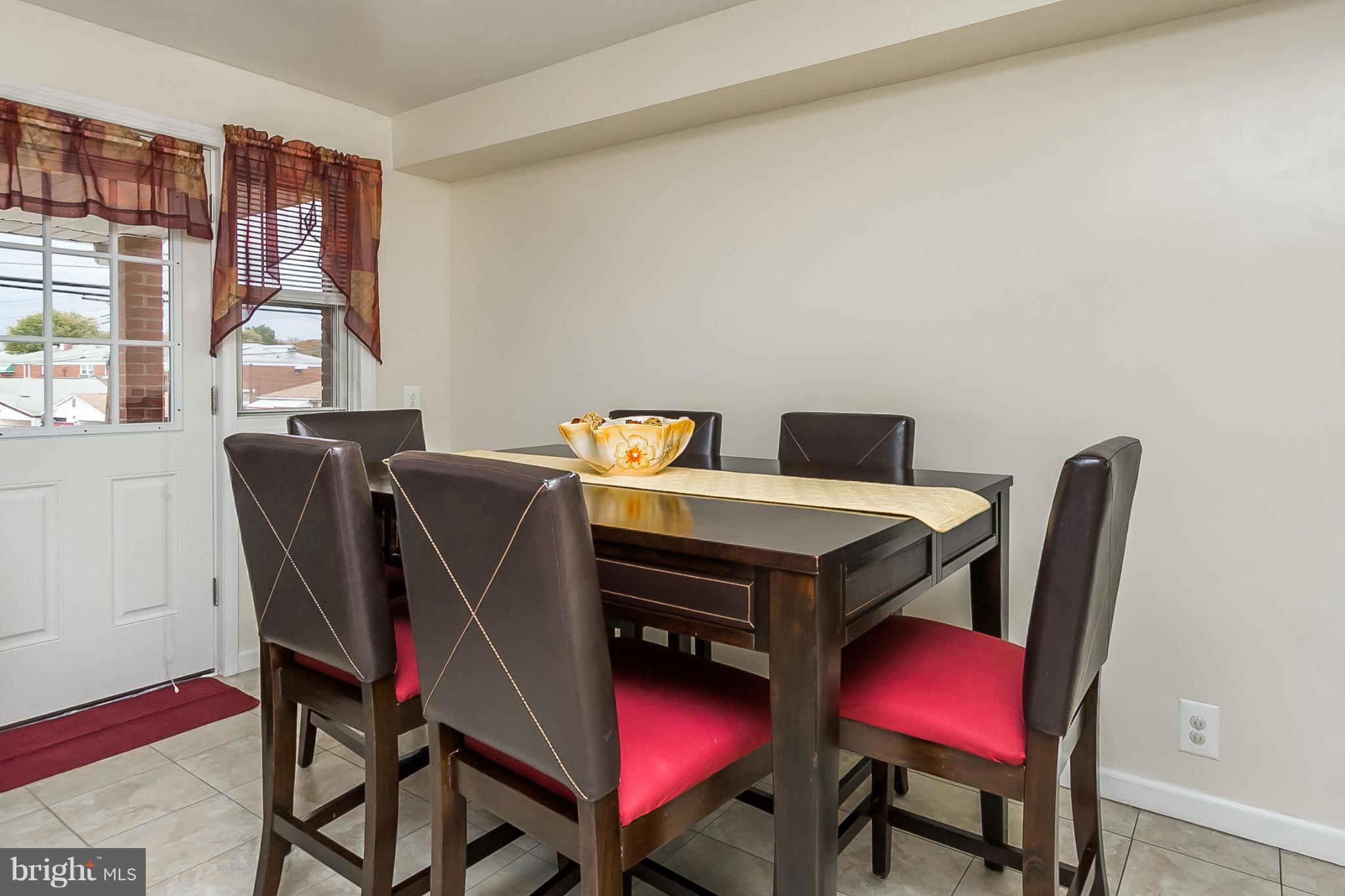 716 Aldworth Road Baltimore, MD 21222 - Photo 11 of 29 a view of a dining room with furniture and a window