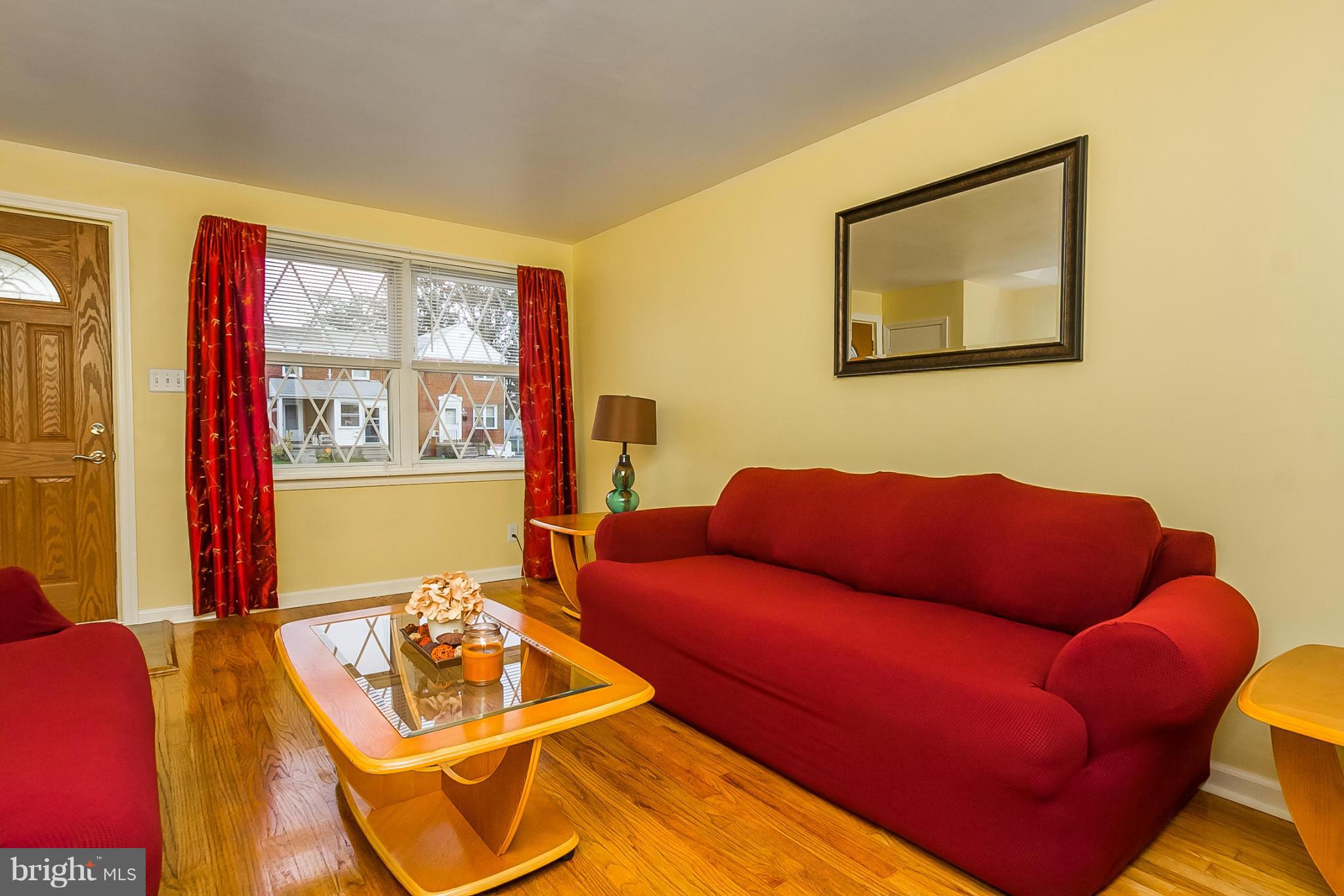 716 Aldworth Road Baltimore, MD 21222 - Photo 12 of 29 a living room with furniture and a floor to ceiling window