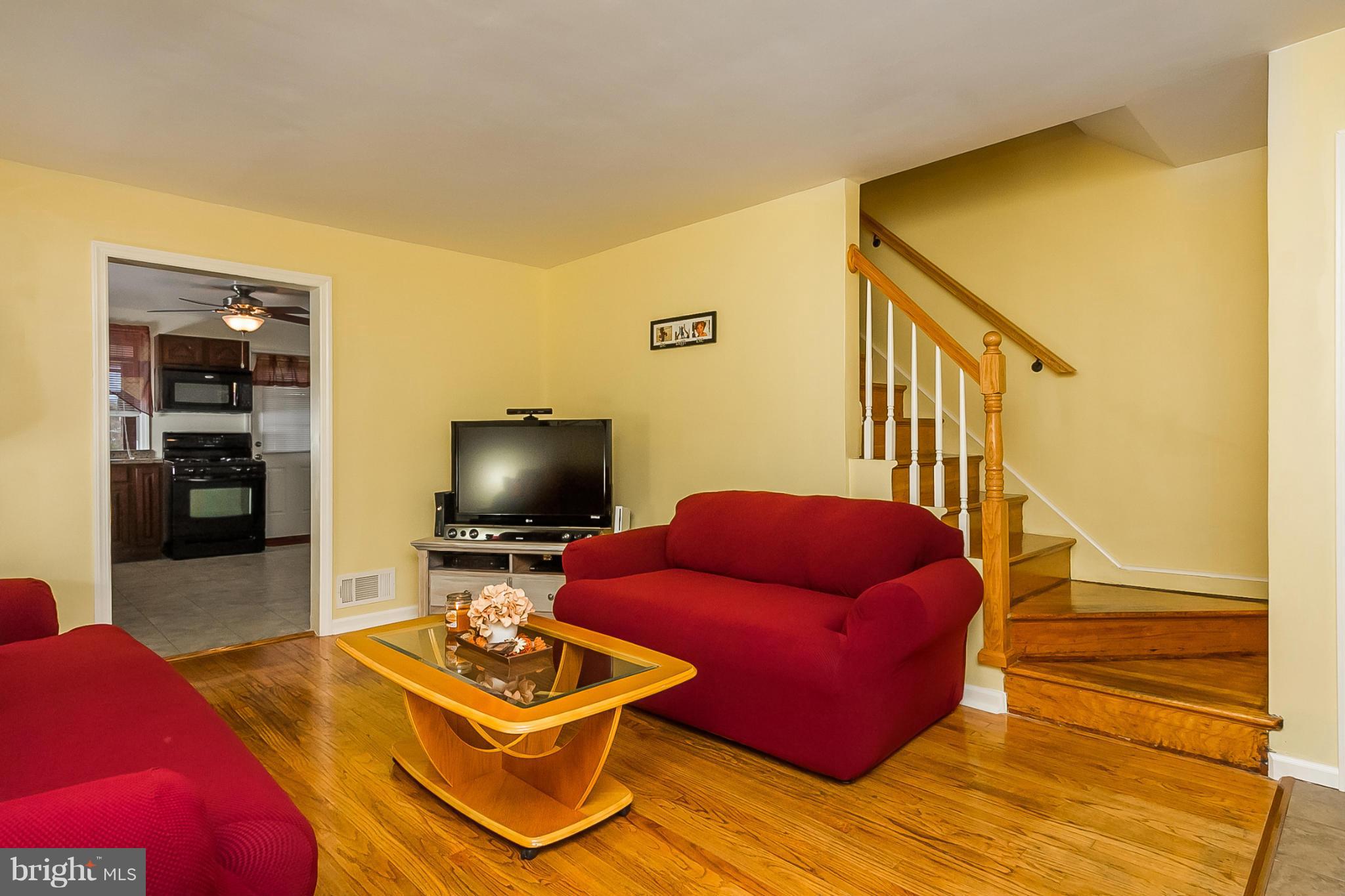 716 Aldworth Road Baltimore, MD 21222 - Photo 15 of 29 a living room with furniture and a wooden floor