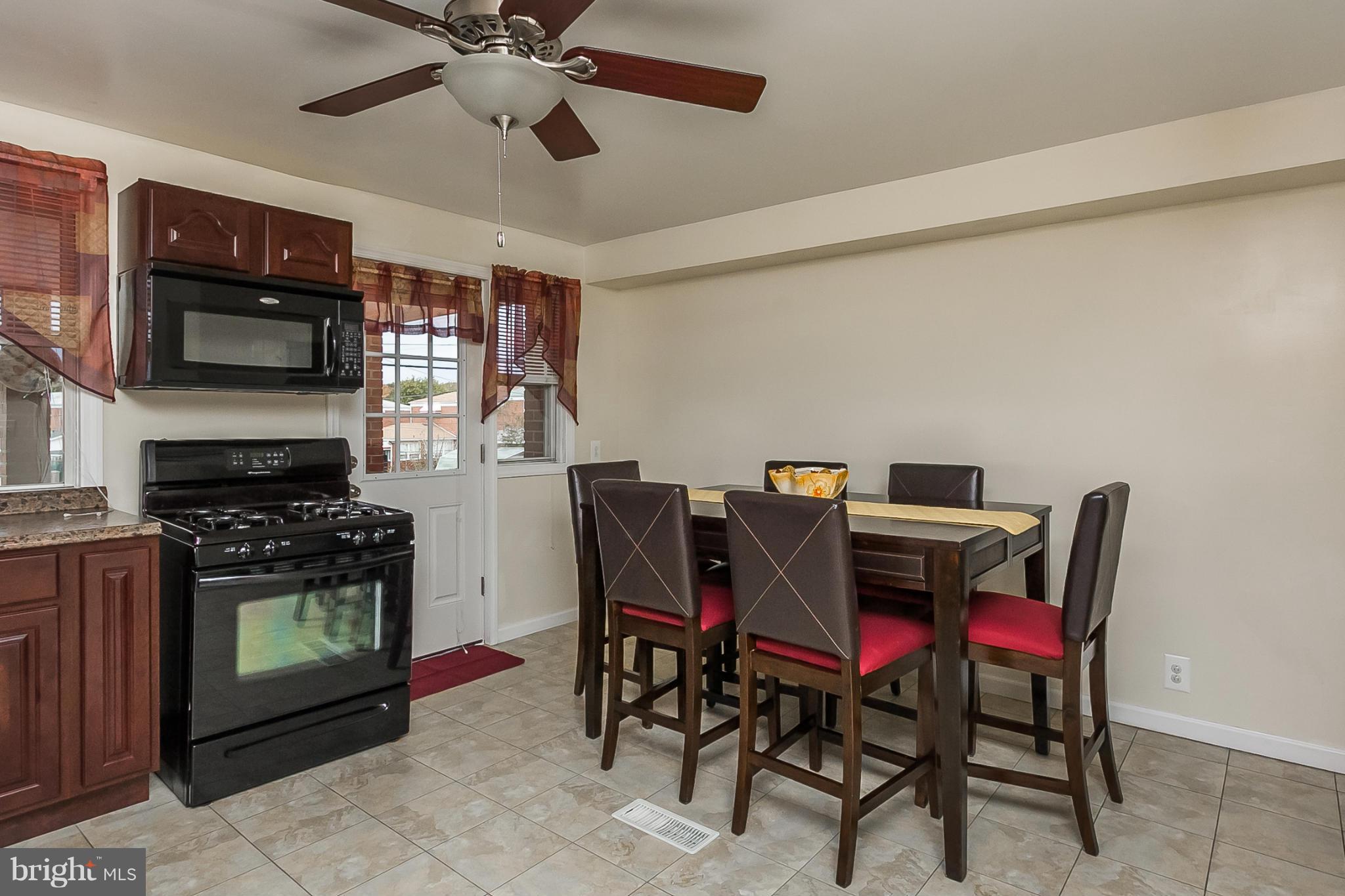 716 Aldworth Road Baltimore, MD 21222 - Photo 16 of 29 a view of a dining room with furniture and a chandelier fan