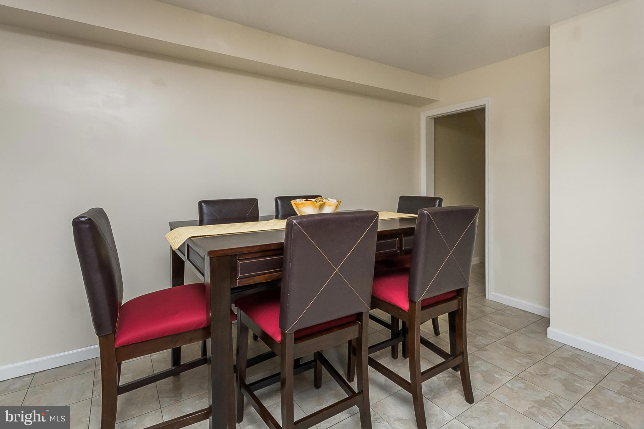 716 Aldworth Road Baltimore, MD 21222 - Photo 17 of 29 a view of a dining room with furniture and a window