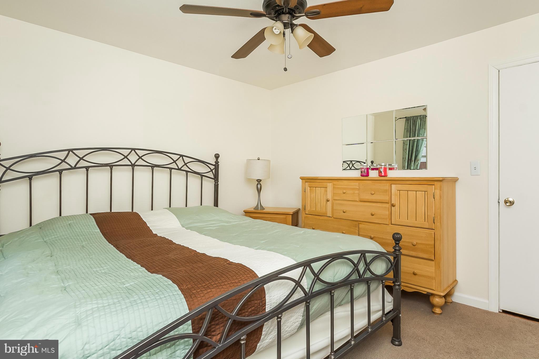 716 Aldworth Road Baltimore, MD 21222 - Photo 19 of 29 a bedroom with a bed and a chandelier