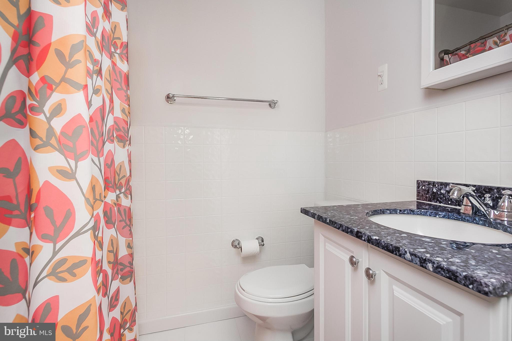 716 Aldworth Road Baltimore, MD 21222 - Photo 9 of 29 a bathroom with a granite countertop sink and a toilet