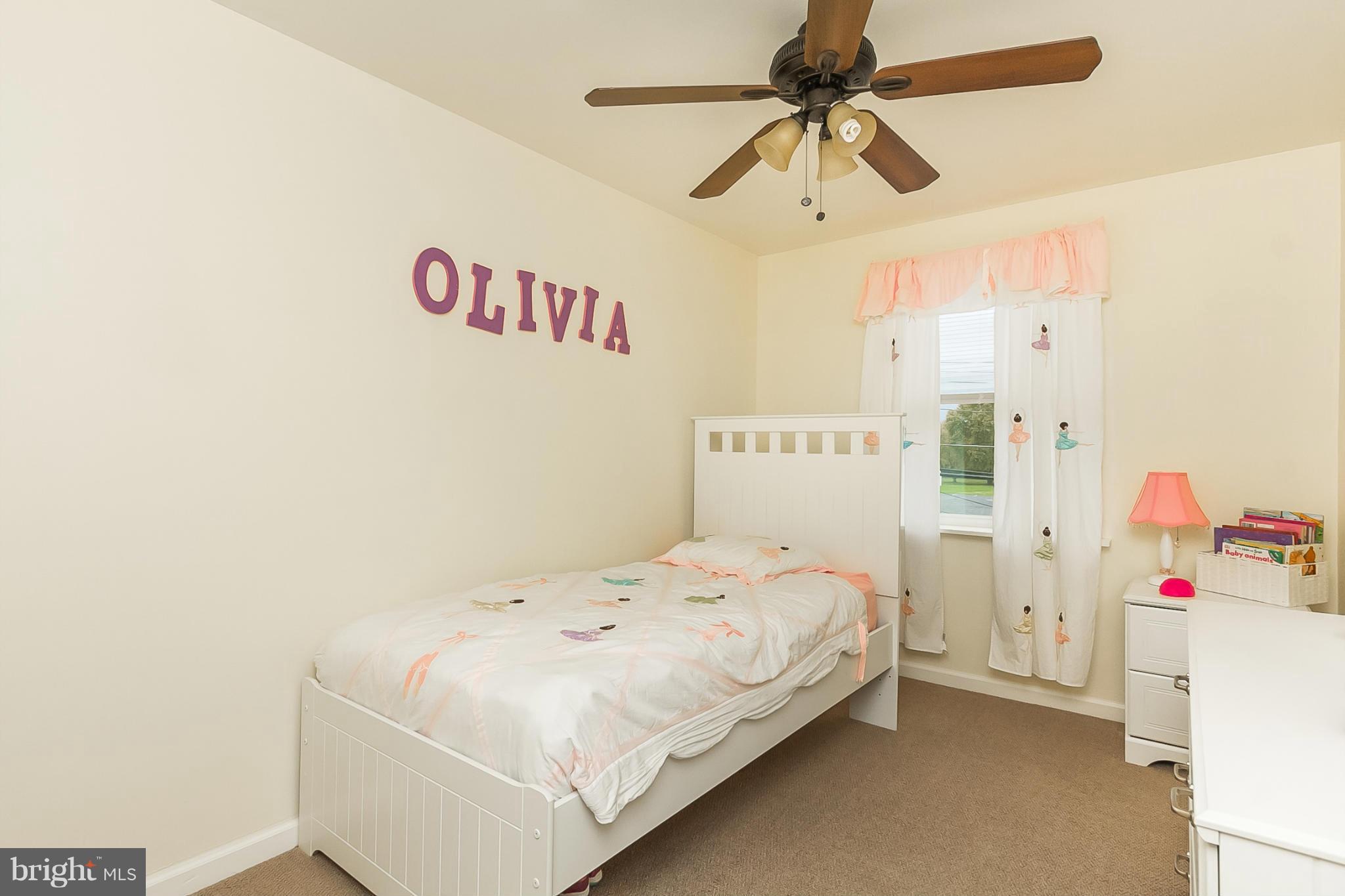 716 Aldworth Road Baltimore, MD 21222 - Photo 10 of 29 a bedroom with a bed and a chandelier