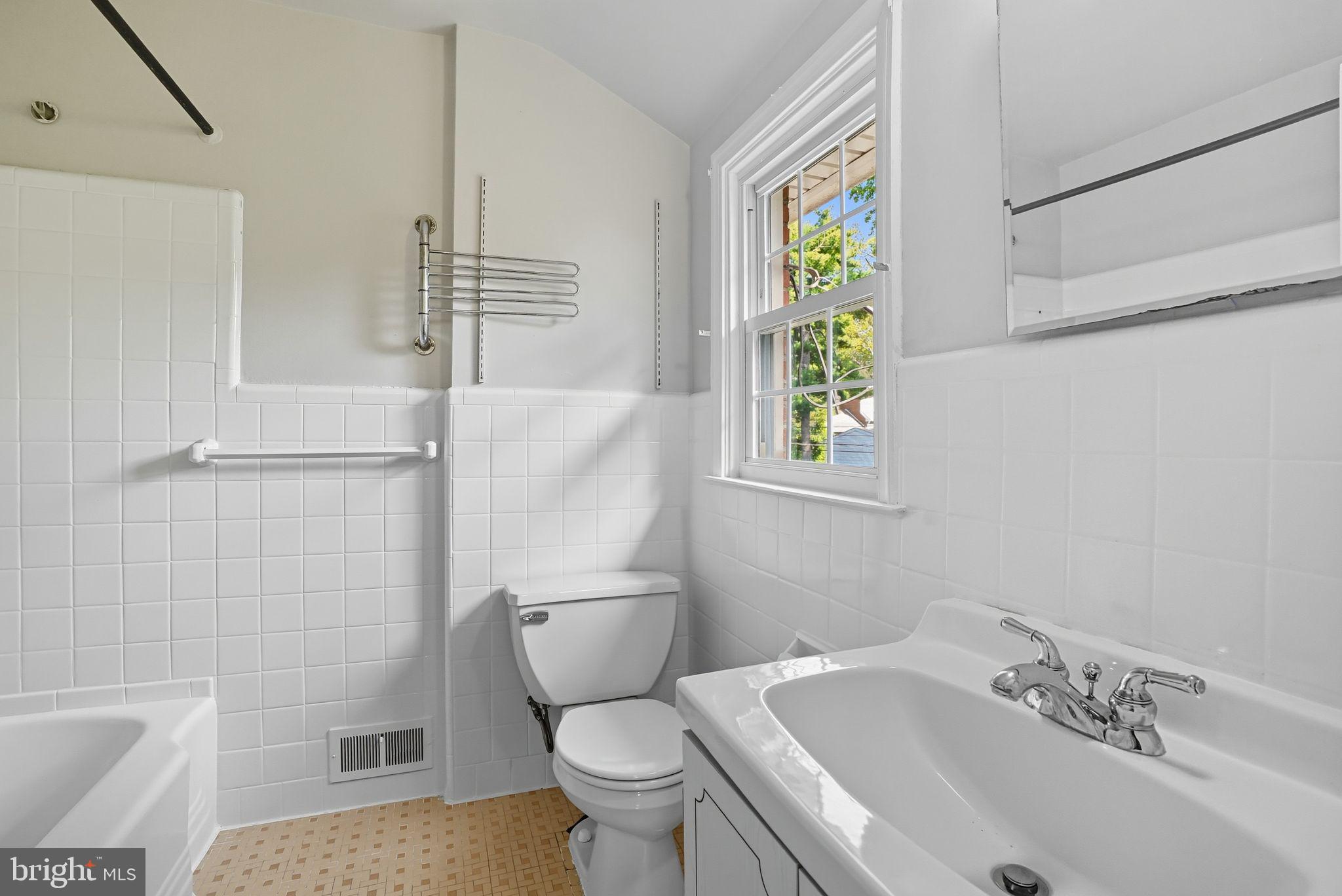 979 Edgewood Drive Springfield, PA 19064 - Photo 23 of 36 a white toilet sitting next to a bathroom sink and tub